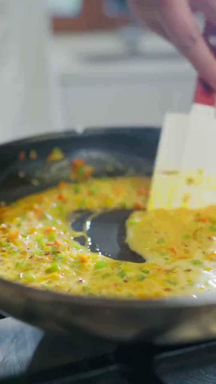 Cilantro cayendo sobre camarones en salsa amarilla